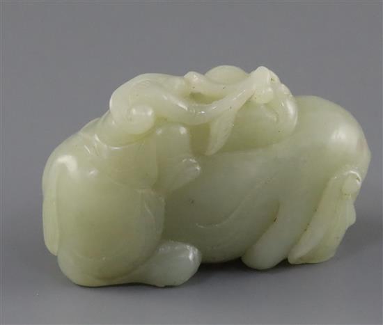 A Chinese pale celadon jade group of a boy on a recumbent elephant, 19th century, L.6.5cm